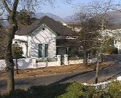 The view from Squirrel & Vine apartment's balcony shows historic central Stellenbosch buildings